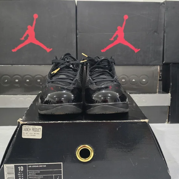 This is a pair of Air Jordan 2009 'S23' sneakers in the black and metallic gold